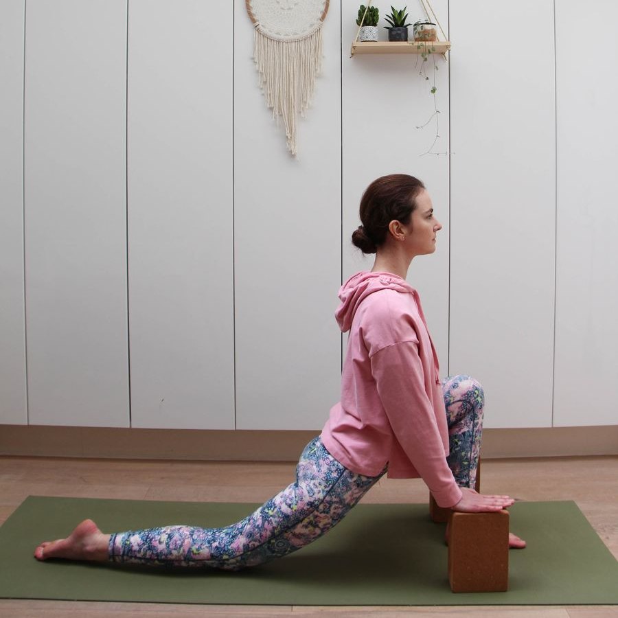 Daria demonstrating a supported lunge with yoga blocks